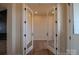 Glass French doors open to a home office featuring sleek wood flooring, plenty of light, and modern accents at 1429 Coppergate Dr, Salisbury, NC 28147