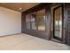 A covered outdoor patio with a seamless transition to the interior via a dark-framed glass door and matching windows at 1429 Coppergate Dr, Salisbury, NC 28147