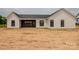 A view of the home's rear exterior featuring clean lines, a covered patio, and a dark-colored roof at 1429 Coppergate Dr, Salisbury, NC 28147