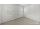 Bright bedroom with neutral walls, plush carpeting, and two windows for ample natural light at 14328 Evening Flight Ln, Charlotte, NC 28262