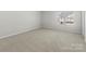 Cozy bedroom with plush carpeting and a large window providing natural light at 14328 Evening Flight Ln, Charlotte, NC 28262
