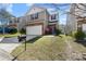 Charming two-story home with a brick and siding exterior, a two-car garage, and a well-manicured lawn at 14328 Evening Flight Ln, Charlotte, NC 28262