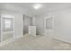 Spacious hallway with plush carpeting that connects multiple rooms at 14328 Evening Flight Ln, Charlotte, NC 28262