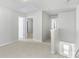 Bright hallway features neutral carpeting and classic doors at 14328 Evening Flight Ln, Charlotte, NC 28262