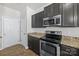 Galley style kitchen with stainless steel appliances and granite countertops at 14328 Evening Flight Ln, Charlotte, NC 28262