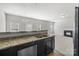 Open kitchen with a view of the fireplace, stainless steel dishwasher, and granite countertops at 14328 Evening Flight Ln, Charlotte, NC 28262