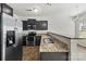 Stainless steel refrigerator and modern kitchen with granite countertops and breakfast bar seating at 14328 Evening Flight Ln, Charlotte, NC 28262