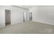 Large carpeted main bedroom with multiple closets and neutral walls at 14328 Evening Flight Ln, Charlotte, NC 28262