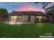 Virtually enhanced backyard with a green lawn and neutral home exterior at 14827 Smith Rd, Charlotte, NC 28273