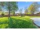 Expansive backyard with lush green grass, mature trees, a storage shed, and a privacy fence at 14827 Smith Rd, Charlotte, NC 28273