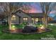 Landscaped front yard featuring stone feature and lighting at 14827 Smith Rd, Charlotte, NC 28273