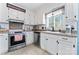 Bright kitchen featuring white cabinets, stainless steel appliances and modern fixtures at 14827 Smith Rd, Charlotte, NC 28273
