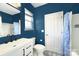 Stylish bathroom with dark blue walls, a modern vanity, and a patterned tile floor at 14911 Barnsbury Dr, Huntersville, NC 28078