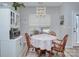 Cozy dining area featuring a round wooden table, charming chairs, and lots of natural light at 14911 Barnsbury Dr, Huntersville, NC 28078