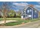 Inviting two-story house featuring a manicured lawn, a charming patio, and lush greenery, creating a warm exterior view at 14911 Barnsbury Dr, Huntersville, NC 28078