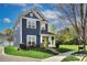 Charming two-story home featuring a bright yellow front door and well-manicured lawn at 14911 Barnsbury Dr, Huntersville, NC 28078