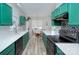 Modern kitchen features sleek countertops, black appliances, and charming green cabinets at 14911 Barnsbury Dr, Huntersville, NC 28078