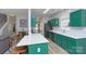 Open kitchen with an island, stainless steel refrigerator and sink, and trendy green cabinets at 14911 Barnsbury Dr, Huntersville, NC 28078