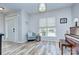 Bright living room featuring a light-filled window, wood floors, and comfortable seating area at 14911 Barnsbury Dr, Huntersville, NC 28078