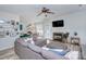 Inviting living room featuring a fireplace, ceiling fan and view into the kitchen at 14911 Barnsbury Dr, Huntersville, NC 28078