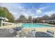 Expansive pool with ample seating, and a water slide, perfect for relaxation and outdoor fun at 14911 Barnsbury Dr, Huntersville, NC 28078