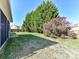 Secluded backyard featuring a lush lawn, mature trees, and privacy fence at 15506 Lakepoint Forest Dr, Charlotte, NC 28278