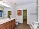 A spacious bathroom with double sinks, vanity, tile flooring, and a soaking tub at 15506 Lakepoint Forest Dr, Charlotte, NC 28278