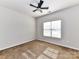 Cozy bedroom featuring a ceiling fan and natural light from a window at 15506 Lakepoint Forest Dr, Charlotte, NC 28278