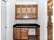 Functional built-in desk with granite countertop and storage cabinets, creating a dedicated workspace at 15506 Lakepoint Forest Dr, Charlotte, NC 28278