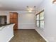 Bright dining area features tile floors, a large window, and stylish light fixture at 15506 Lakepoint Forest Dr, Charlotte, NC 28278