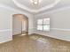 Dining room with archway, chair rail, window, and tile flooring at 15506 Lakepoint Forest Dr, Charlotte, NC 28278
