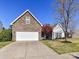 Home with stone accents, attached two-car garage, well manicured lawn, and mature landscaping at 15506 Lakepoint Forest Dr, Charlotte, NC 28278