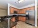 Well-equipped kitchen with granite countertops, stainless appliances, tile floor, and wood cabinets at 15506 Lakepoint Forest Dr, Charlotte, NC 28278