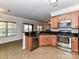 Modern kitchen with stainless appliances, tile flooring, granite countertops, and seamless flow to living spaces at 15506 Lakepoint Forest Dr, Charlotte, NC 28278