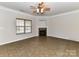 Spacious living room features tile floors, a ceiling fan, fireplace, and a window with natural light at 15506 Lakepoint Forest Dr, Charlotte, NC 28278