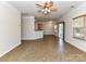 Open-concept living room with tile floors, open to the kitchen and adjacent to the sliding glass door at 15506 Lakepoint Forest Dr, Charlotte, NC 28278