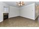 Open living room with tile floors, fireplace, ceiling fan, and neutral walls offers a versatile layout at 15506 Lakepoint Forest Dr, Charlotte, NC 28278