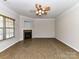 Bright living room featuring tile floors, fireplace, and a ceiling fan, awaiting personalization and decor at 15506 Lakepoint Forest Dr, Charlotte, NC 28278