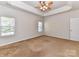 Large main bedroom features carpet flooring, multiple windows, and a ceiling fan at 15506 Lakepoint Forest Dr, Charlotte, NC 28278