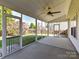 Enclosed screen porch with ceiling fan offering outdoor views and access to backyard at 15506 Lakepoint Forest Dr, Charlotte, NC 28278