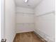 Walk in closet with metal shelving units and carpet flooring at 15506 Lakepoint Forest Dr, Charlotte, NC 28278