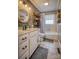 Charming bathroom featuring a modern vanity with a round mirror, wooden accents, and a bathtub with shower, blending style and functionality at 198 33Rd Nw St, Hickory, NC 28601