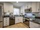 Charming kitchen featuring white cabinetry, black countertops and stainless steel appliances, including a sleek microwave and oven at 198 33Rd Nw St, Hickory, NC 28601