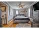Spacious main bedroom featuring a wooden ceiling fan and a comfortable bed with hardwood floors and a stylish rug at 198 33Rd Nw St, Hickory, NC 28601