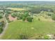 Expansive aerial view of the property showcasing surrounding greenery, scattered homes, and a picturesque country landscape at 201 Lee Black Rd, Cherryville, NC 28021