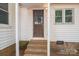The back entrance features a rustic, wood-paneled door and brick steps at 201 Lee Black Rd, Cherryville, NC 28021