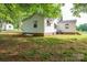 The backyard features a white home with an air conditioning unit and brick foundation at 201 Lee Black Rd, Cherryville, NC 28021