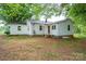 Backyard view of home with white siding and mature shade trees at 201 Lee Black Rd, Cherryville, NC 28021