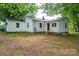 The back of the home features white siding, a brick foundation and a covered entrance at 201 Lee Black Rd, Cherryville, NC 28021