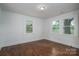 Spacious bedroom features wood floors, white trim, and backyard views at 201 Lee Black Rd, Cherryville, NC 28021